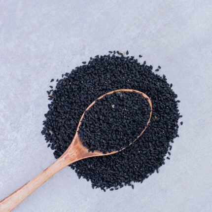 showcasing their small, oval shape and dark black color. The seeds appear glossy and rich in texture.