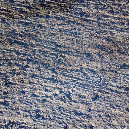 a unique and striking natural stone with a blue-gray background and waves of white and beige, resembling the movement of sand dunes.