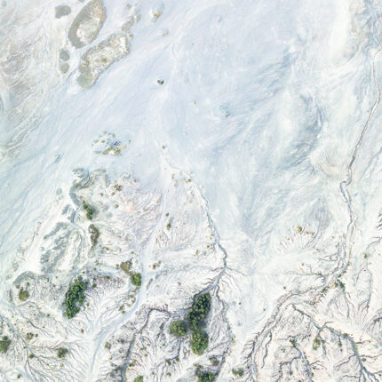 a captivating natural stone with a white background and swirling patterns of blue and gray, reminiscent of a galaxy in motion.