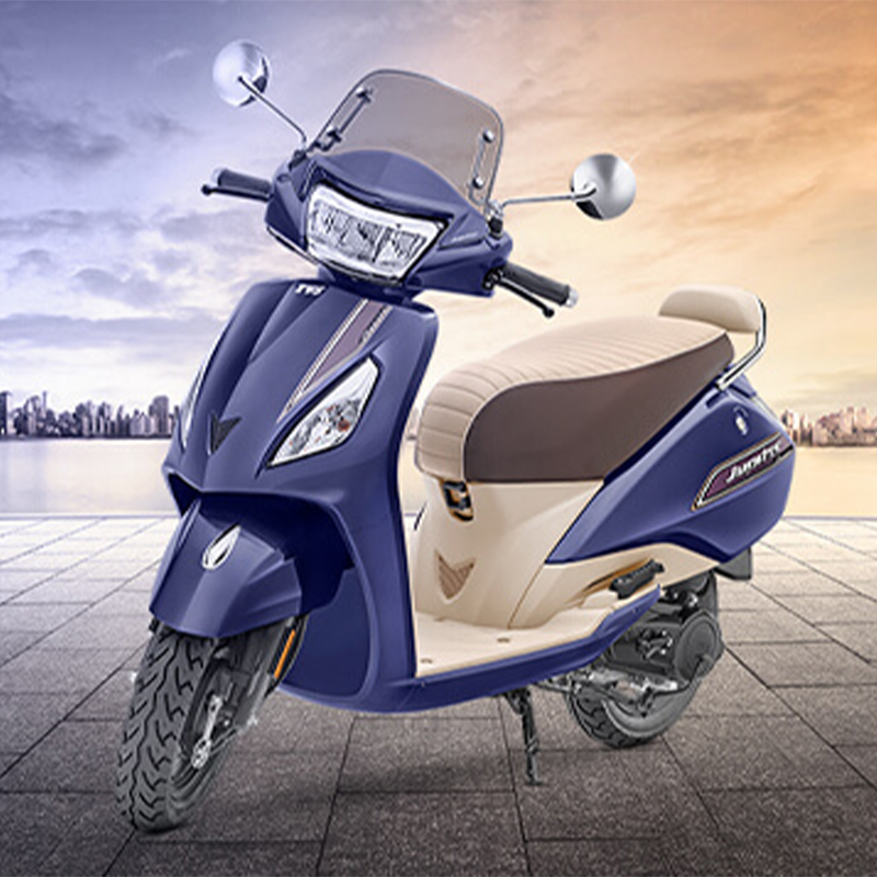 TVS Jupiter 2 The scooter has a sleek and elegant design with a distinctive front apron, a wide and comfortable seat, and a large pillion grab rail. It features telescopic front suspension for a smooth ride, alloy wheels for stability, and a fuel-efficient engine. The Jupiter is known for its practicality, reliability, and user-friendly features, including a digital instrument cluster, external fuel filler cap, and ample storage space, making it a popular choice for daily commuting and city riding.