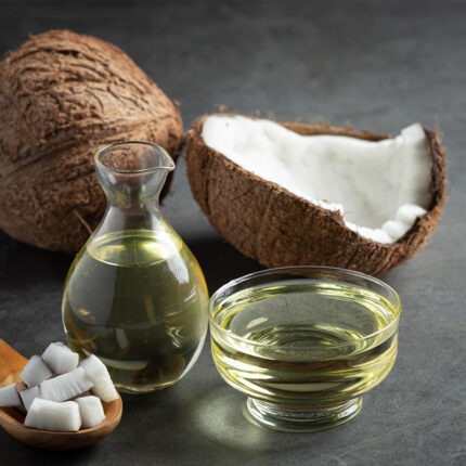 showcasing its clear, golden-yellow liquid texture. The oil appears to be smooth and glossy, with a rich and natural hue. Virgin coconut oil is often used in cooking, skincare, and hair care due to its natural properties.