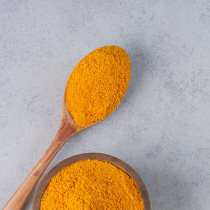 A pile of golden-yellow, fine powder, likely made from ground lentils or dhal, with a slightly granular texture.