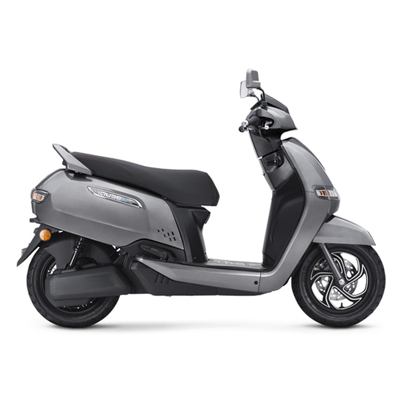 iqube-electric6285bdf21115c The scooter features a modern and futuristic design with sharp lines, LED lighting, and a large windscreen. It has a compact body, alloy wheels, and a digital instrument cluster. The scooter is powered by an electric motor and has a removable Lithium-Ion battery, offering a range of up to 75 km per charge. It also has regenerative braking, smartphone connectivity, and a reverse assist feature. The alt text highlights the scooter's electric powertrain, advanced features, and distinctive appearance.