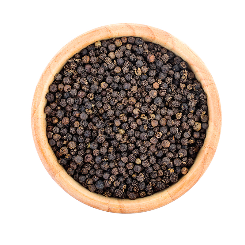 peppercorn-wood-bowl-white-wall Black peppercorns in a bowl, commonly used as a spice in cooking and seasoning, known for their pungent and slightly spicy flavor.