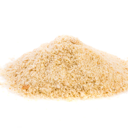 displaying a fine, light brown powder with a smooth texture. The husk particles are visible, indicating the fibrous nature of psyllium.