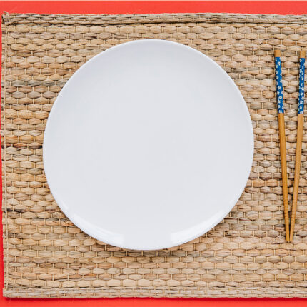 This plate features an embossed pattern on its surface, adding a touch of texture and visual interest. The raised edges help contain the rice and prevent it from spilling over.