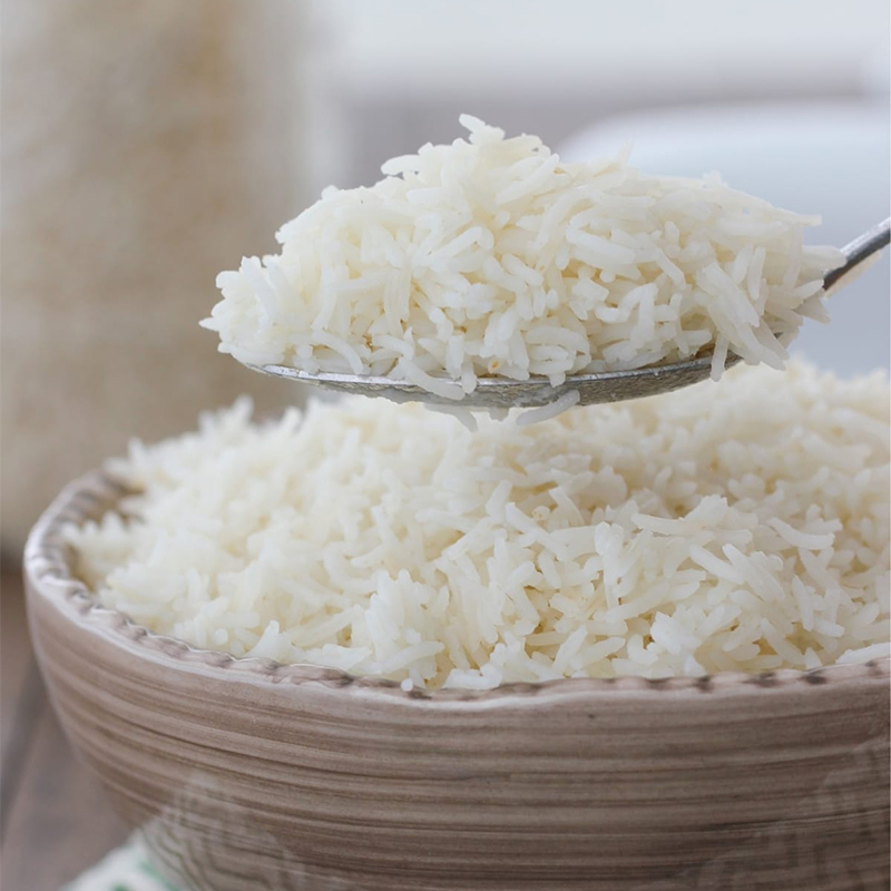 Long Grain White Rice_ The image may show a bowl of cooked long-grain white rice or a pile of uncooked rice grains. Long-grain white rice is the most common type of rice consumed worldwide.
