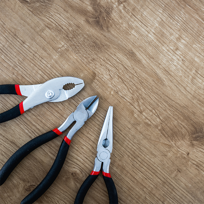 Pliers A pair of pliers, a hand-held tool with two handles and a pivot point, used for gripping, bending, and cutting materials such as wire and metal. Pliers come in a variety of shapes and sizes, including needle-nose pliers, slip-joint pliers, and wire cutters, and are commonly used in electrical work, automotive repair, and other applications that require precision gripping and manipulation of materials.