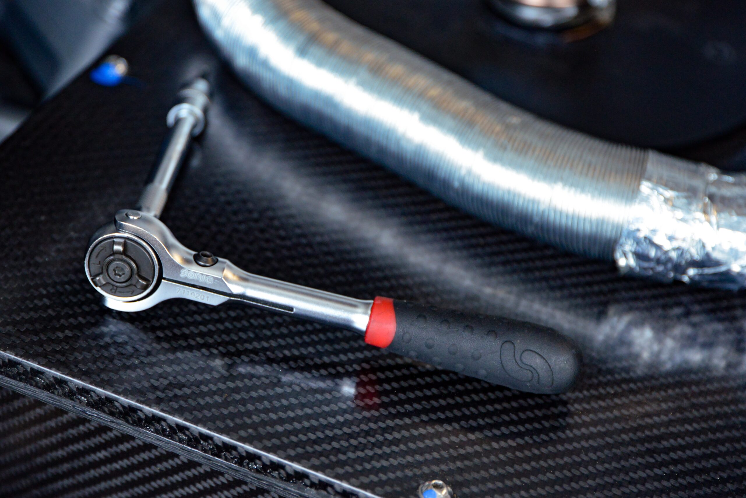 A ratchet, a hand-held tool with a handle and a socket used for turning bolts and nuts. Ratchets have a mechanism that allows the socket to turn in one direction and lock in place when turned in the opposite direction.