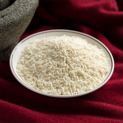 The image may show a bowl of cooked sticky rice or a pile of uncooked rice grains. Sticky rice is a staple in many Southeast Asian cuisines, particularly in dishes such as Thai sticky rice, sticky rice desserts, and sushi.
