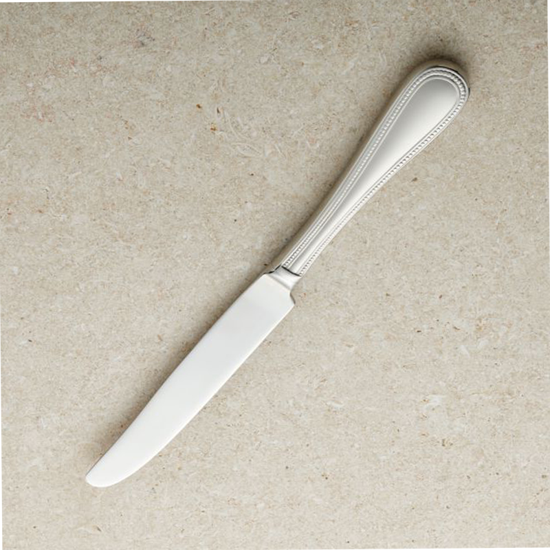 Table knife A table knife, a common utensil used for cutting and spreading food at the dining table. It has a sturdy handle and a sharp, serrated or non-serrated blade, designed for slicing through various types of food, such as meat, vegetables, and bread.
